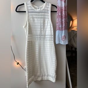 White dress. Exposed on top of chest and exposed below chest.